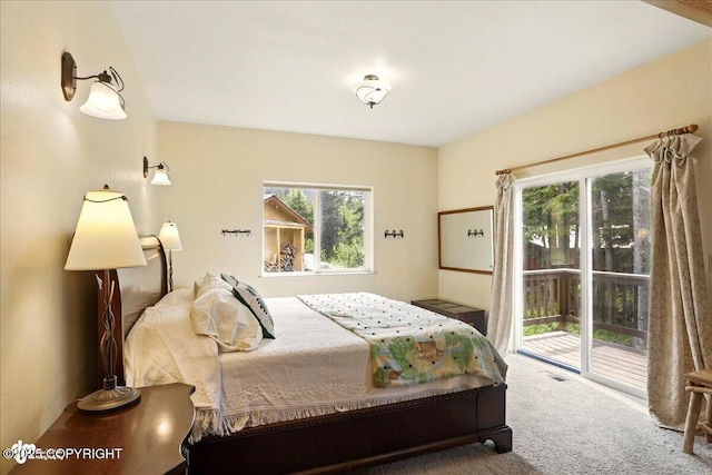 142 Vail Cir, Girdwood, AK 99587 - bedroom with access to exterior, multiple windows, and carpet floors