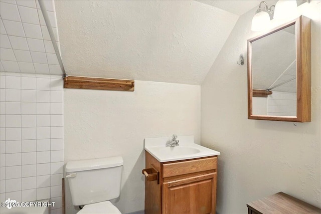 142 Vail Cir, Girdwood, AK 99587 - bathroom featuring vaulted ceiling, toilet, and vanity