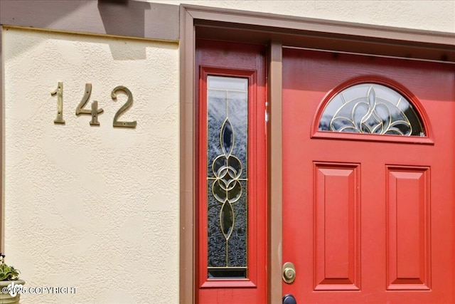 142 Vail Cir, Girdwood, AK 99587 - property entrance with stucco siding