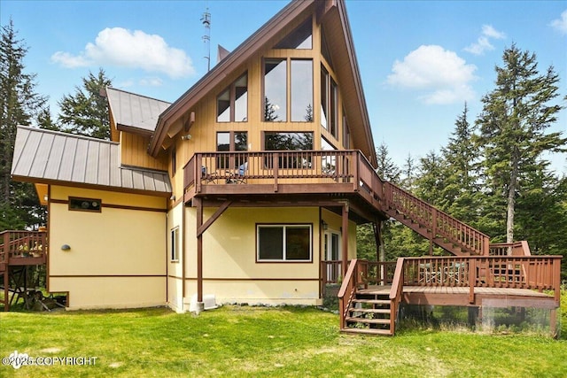 142 Vail Cir, Girdwood, AK 99587 - rear view of property featuring stairway, a wooden deck, a standing seam roof, a lawn, and metal roof