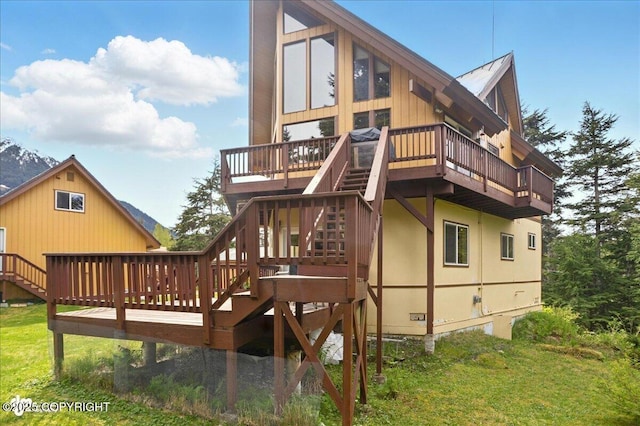 142 Vail Cir, Girdwood, AK 99587 - rear view of property with a wooden deck, stairs, and a lawn