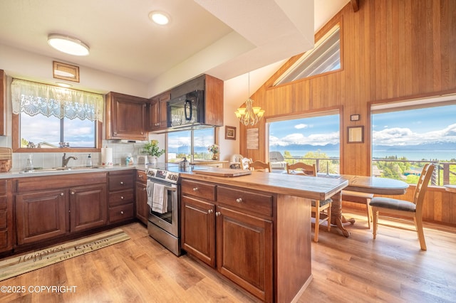 292 Mountain View Dr, Homer, AK 99603 - kitchen with black microwave, a chandelier, electric stove, light wood-style flooring, and wooden walls