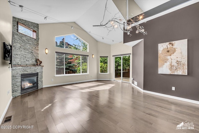 268 Dailey Ave, Anchorage, AK 99515 - unfurnished living room with high vaulted ceiling, a chandelier, wood finished floors, and baseboards