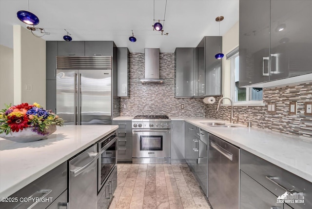 268 Dailey Ave, Anchorage, AK 99515 - kitchen featuring high end appliances, gray cabinets, a sink, wall chimney range hood, and modern cabinets