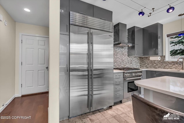 268 Dailey Ave, Anchorage, AK 99515 - kitchen with high quality appliances, gray cabinetry, wall chimney range hood, a sink, and recessed lighting