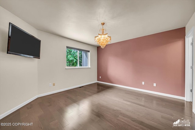268 Dailey Ave, Anchorage, AK 99515 - unfurnished room with a chandelier, baseboards, and wood finished floors