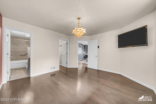 268 Dailey Ave, Anchorage, AK 99515 - unfurnished dining area featuring wood finished floors, a chandelier, and baseboards