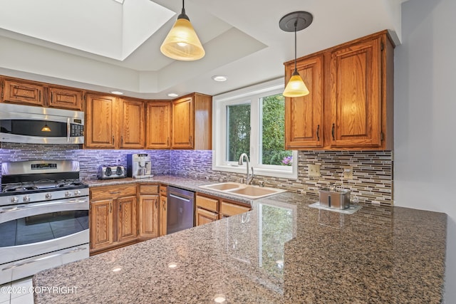 11751 Mary Ave, Anchorage, AK 99515 - kitchen featuring appliances with stainless steel finishes, dark stone countertops, brown cabinetry, decorative light fixtures, and backsplash