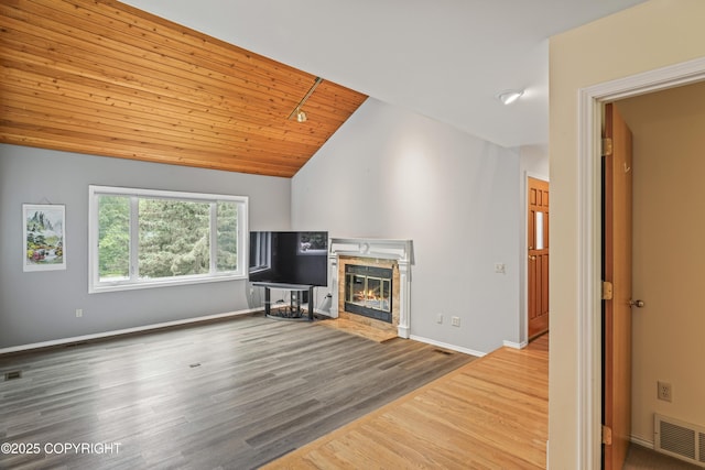 11751 Mary Ave, Anchorage, AK 99515 - unfurnished living room with lofted ceiling, a fireplace with flush hearth, wood finished floors, and wood ceiling