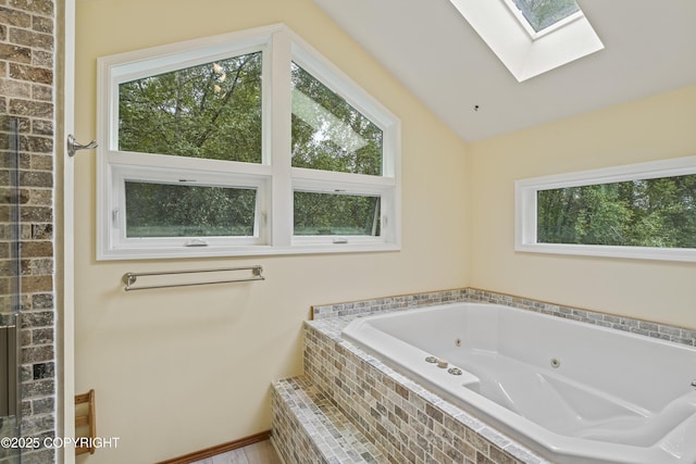 11751 Mary Ave, Anchorage, AK 99515 - bathroom featuring a skylight, healthy amount of natural light, a jetted tub, and lofted ceiling