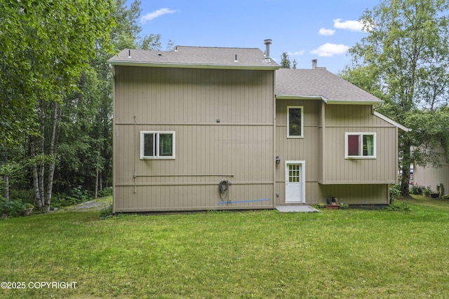 11751 Mary Ave, Anchorage, AK 99515 - rear view of house featuring roof with shingles, a yard, and a chimney