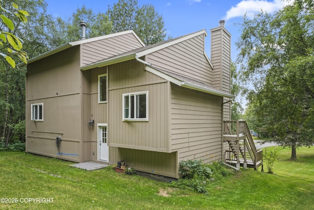 11751 Mary Ave, Anchorage, AK 99515 - view of side of property with a chimney, a lawn, and stairway