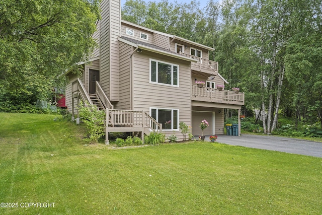 11751 Mary Ave, Anchorage, AK 99515 - view of front facade featuring a garage, asphalt driveway, stairs, a front yard, and a balcony