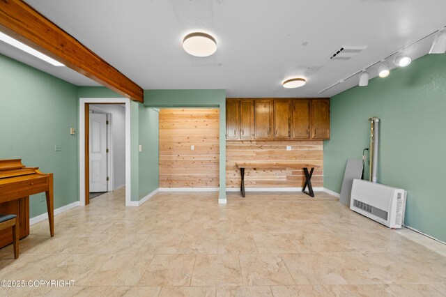 1855 Mission Rd, Homer, AK 99603 - kitchen with track lighting, heating unit, brown cabinets, and wooden walls