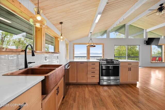 1855 Mission Rd, Homer, AK 99603 - kitchen featuring stainless steel appliances, wood finished floors, decorative backsplash, and hanging light fixtures