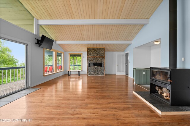 1855 Mission Rd, Homer, AK 99603 - unfurnished living room featuring a wood stove, wood finished floors, a fireplace, high vaulted ceiling, and a wood ceiling with exposed beams