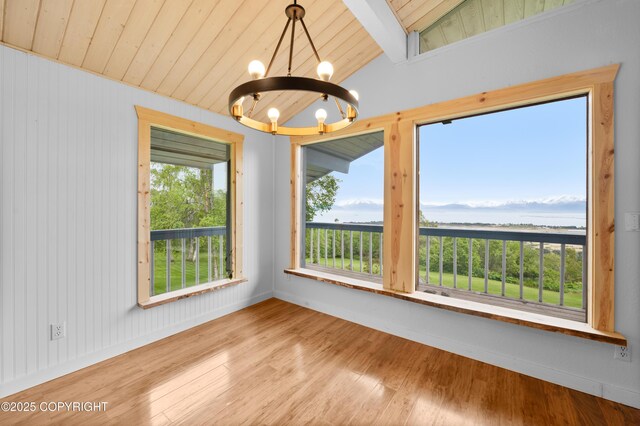 1855 Mission Rd, Homer, AK 99603 - unfurnished room with wood ceiling, a chandelier, a water view, and wood finished floors