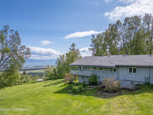 1855 Mission Rd, Homer, AK 99603 - view of side of property featuring a lawn, a shingled roof, and a wooden deck