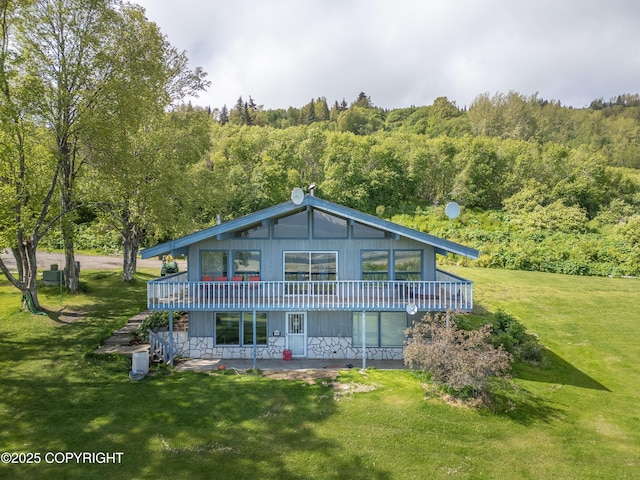 1855 Mission Rd, Homer, AK 99603 - back of house featuring a wooded view, a lawn, a patio area, and a wooden deck