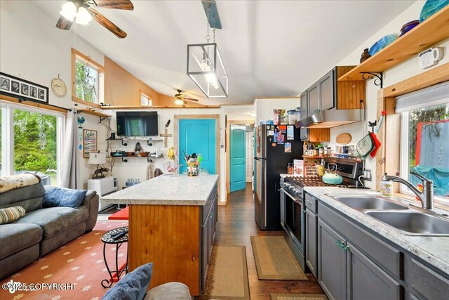 9637 N Buckingham Palace Rd, Willow, AK 99688 - kitchen featuring high end stove, ceiling fan, a sink, light countertops, and a breakfast bar area