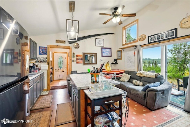 9637 N Buckingham Palace Rd, Willow, AK 99688 - kitchen featuring ceiling fan, lofted ceiling, a center island, light stone countertops, and open floor plan