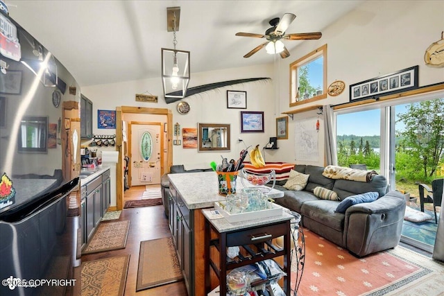 9637 N Buckingham Palace Rd, Willow, AK 99688 - kitchen with freestanding refrigerator, ceiling fan, lofted ceiling, open floor plan, and a center island