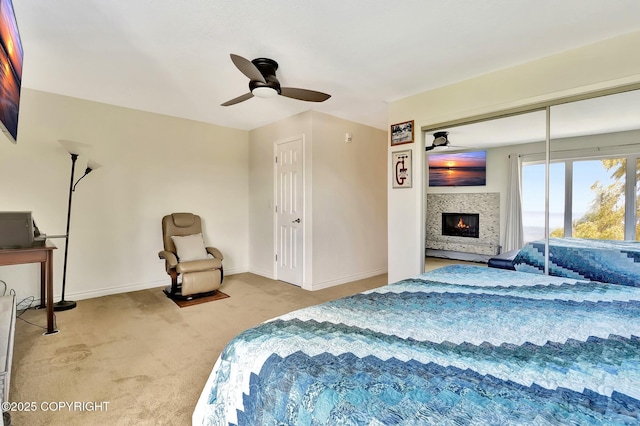 333 M St # 402, Anchorage, AK 99501 - bedroom featuring carpet floors, a glass covered fireplace, baseboards, and ceiling fan