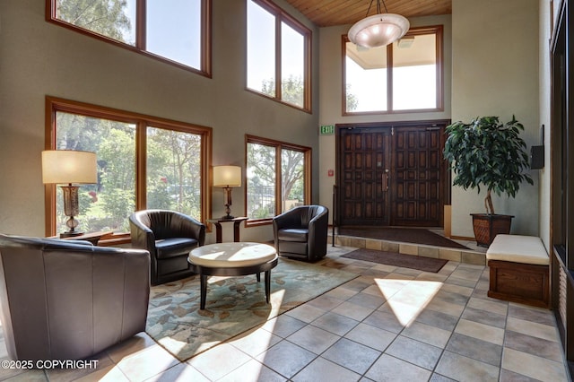 333 M St # 402, Anchorage, AK 99501 - living area featuring light tile patterned floors, a towering ceiling, plenty of natural light, and wood ceiling