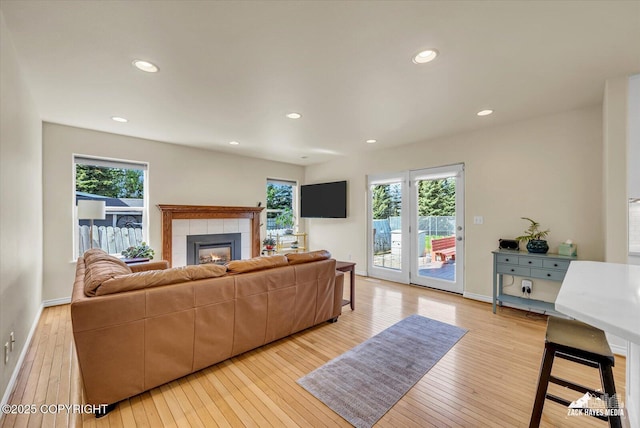 10201 Sextant Cir, Anchorage, AK 99515 - living room with a tiled fireplace, light wood-style flooring, and recessed lighting