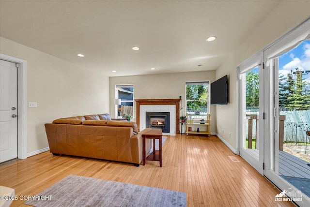 10201 Sextant Cir, Anchorage, AK 99515 - living area featuring light wood finished floors, a tile fireplace, baseboards, and recessed lighting