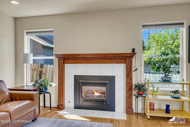 10201 Sextant Cir, Anchorage, AK 99515 - detailed view of a tiled fireplace, wood finished floors, and recessed lighting