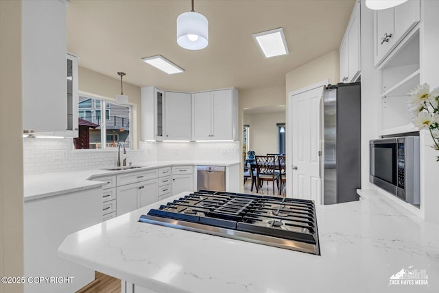 10201 Sextant Cir, Anchorage, AK 99515 - kitchen featuring a sink, stainless steel appliances, backsplash, glass insert cabinets, and white cabinets