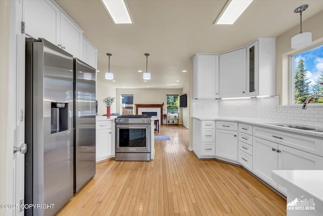10201 Sextant Cir, Anchorage, AK 99515 - kitchen featuring stainless steel appliances, a sink, white cabinetry, recessed lighting, and light countertops