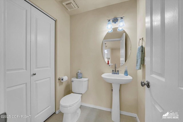10201 Sextant Cir, Anchorage, AK 99515 - bathroom with toilet, baseboards, and a sink