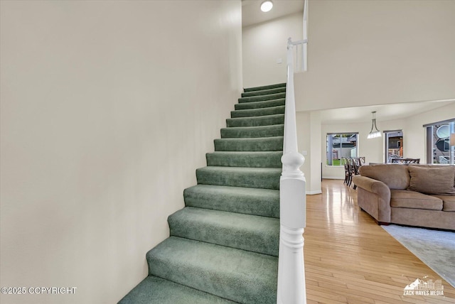 10201 Sextant Cir, Anchorage, AK 99515 - staircase with hardwood / wood-style flooring and a high ceiling