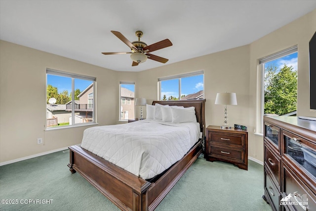 10201 Sextant Cir, Anchorage, AK 99515 - bedroom featuring light colored carpet, baseboards, multiple windows, and ceiling fan