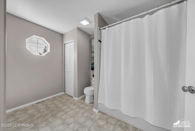 10201 Sextant Cir, Anchorage, AK 99515 - full bathroom with toilet, baseboards, and shower / bath combo with shower curtain