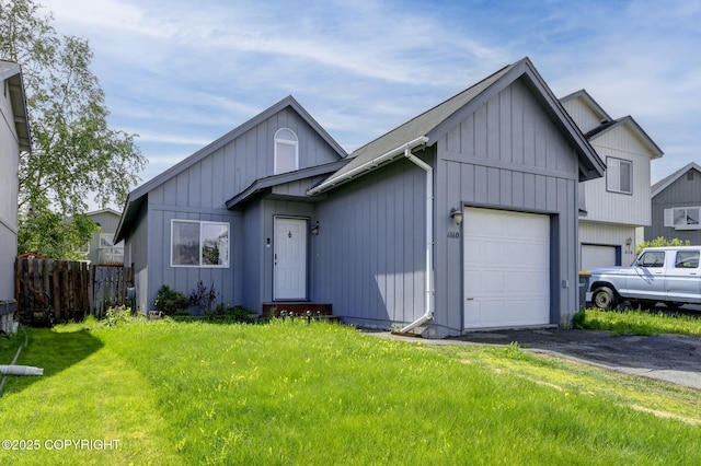 4160 Crannog St, Anchorage, AK 99502 - view of front facade with an attached garage, board and batten siding, and asphalt driveway