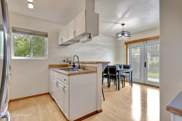 4160 Crannog St, Anchorage, AK 99502 - kitchen featuring a sink, french doors, white cabinets, and light wood-style flooring