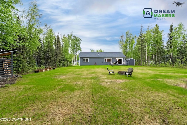 4124 N Coronado St, Wasilla, AK 99623 - view of green lawn with an outdoor fire pit and a shed