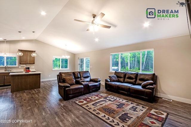 4124 N Coronado St, Wasilla, AK 99623 - living room featuring lofted ceiling, dark wood-style flooring, a ceiling fan, and a chandelier