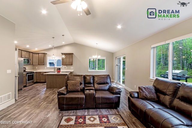 4124 N Coronado St, Wasilla, AK 99623 - living room with wood finished floors, a ceiling fan, lofted ceiling, a chandelier, and recessed lighting