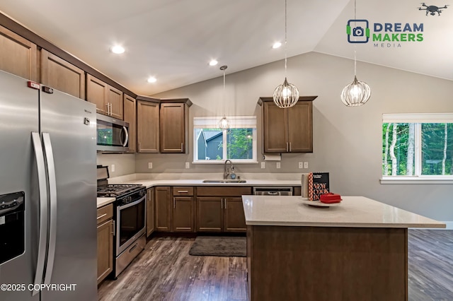 4124 N Coronado St, Wasilla, AK 99623 - kitchen with stainless steel appliances, vaulted ceiling, dark wood-type flooring, decorative light fixtures, and a center island