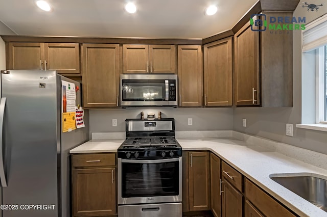 4124 N Coronado St, Wasilla, AK 99623 - kitchen with stainless steel appliances, recessed lighting, and light stone countertops