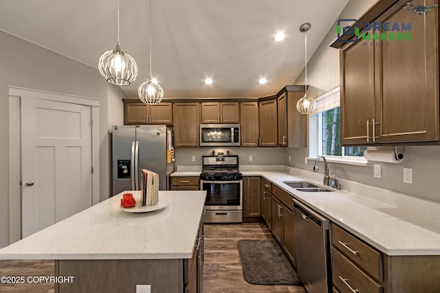 4124 N Coronado St, Wasilla, AK 99623 - kitchen with stainless steel appliances, dark wood-style flooring, recessed lighting, a center island, and light stone counters