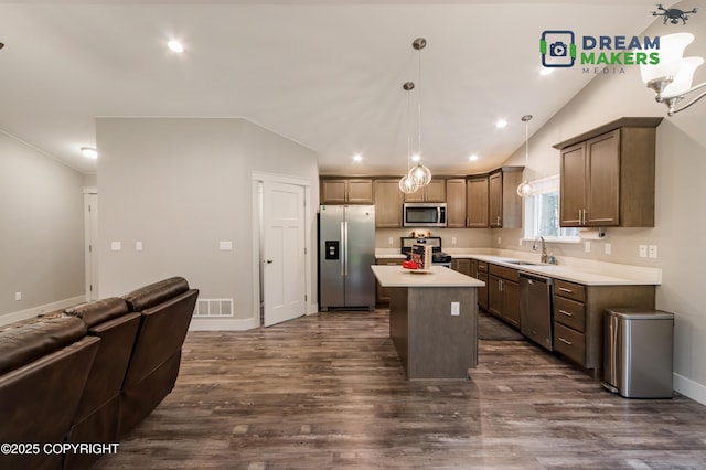 4124 N Coronado St, Wasilla, AK 99623 - kitchen with appliances with stainless steel finishes, lofted ceiling, light countertops, open floor plan, and dark wood-type flooring