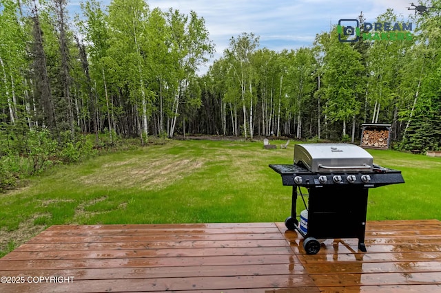 4124 N Coronado St, Wasilla, AK 99623 - wooden terrace featuring a grill and a lawn
