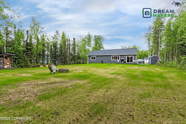 4124 N Coronado St, Wasilla, AK 99623 - view of green lawn featuring a fire pit and a shed