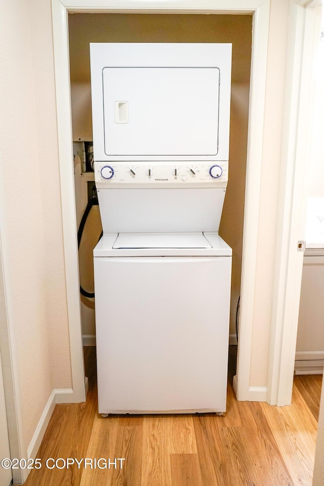 2100 Minerva Way # A6, Anchorage, AK 99515 - washroom with stacked washer / dryer, light wood-type flooring, and baseboards