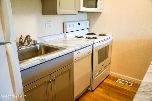 2100 Minerva Way # A6, Anchorage, AK 99515 - kitchen with white appliances, light countertops, light wood-type flooring, and a sink